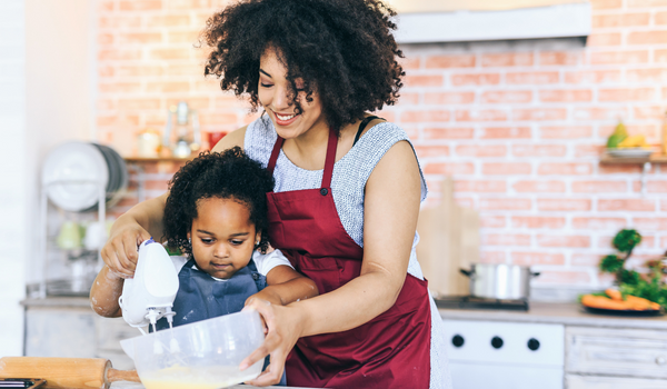 mom and daughter at counter baking in kitchen