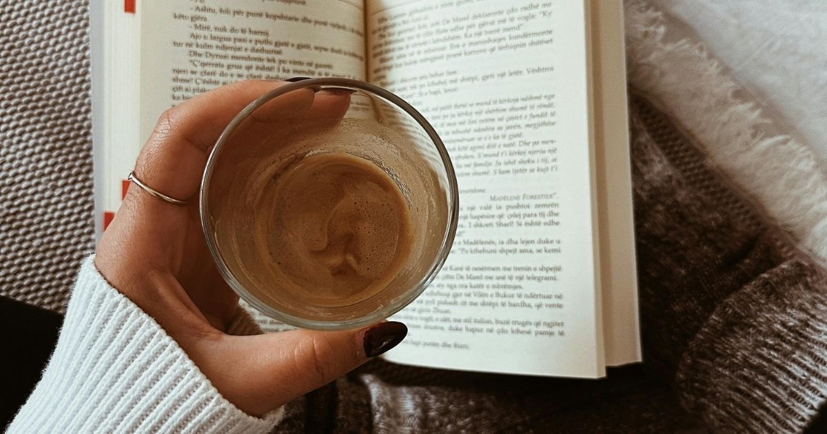 Woman with a book and coffee able to relax in a quiet home