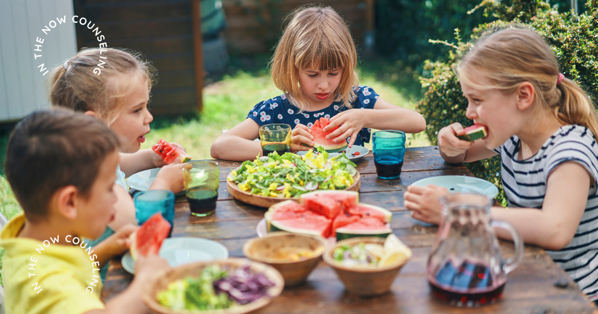 kids eating outside together at a table during summer break which shows their routine