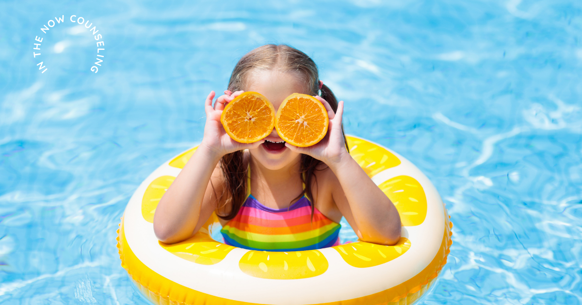 Young girl relaxing in a pool float during summer break, a time when many children experience bigger emotions and changes in routine