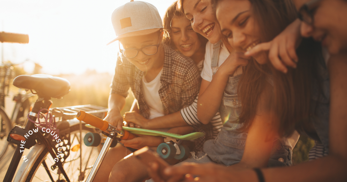 Group of teenagers smiling together outdoors during summer, representing teen friendships and emotional well-being.