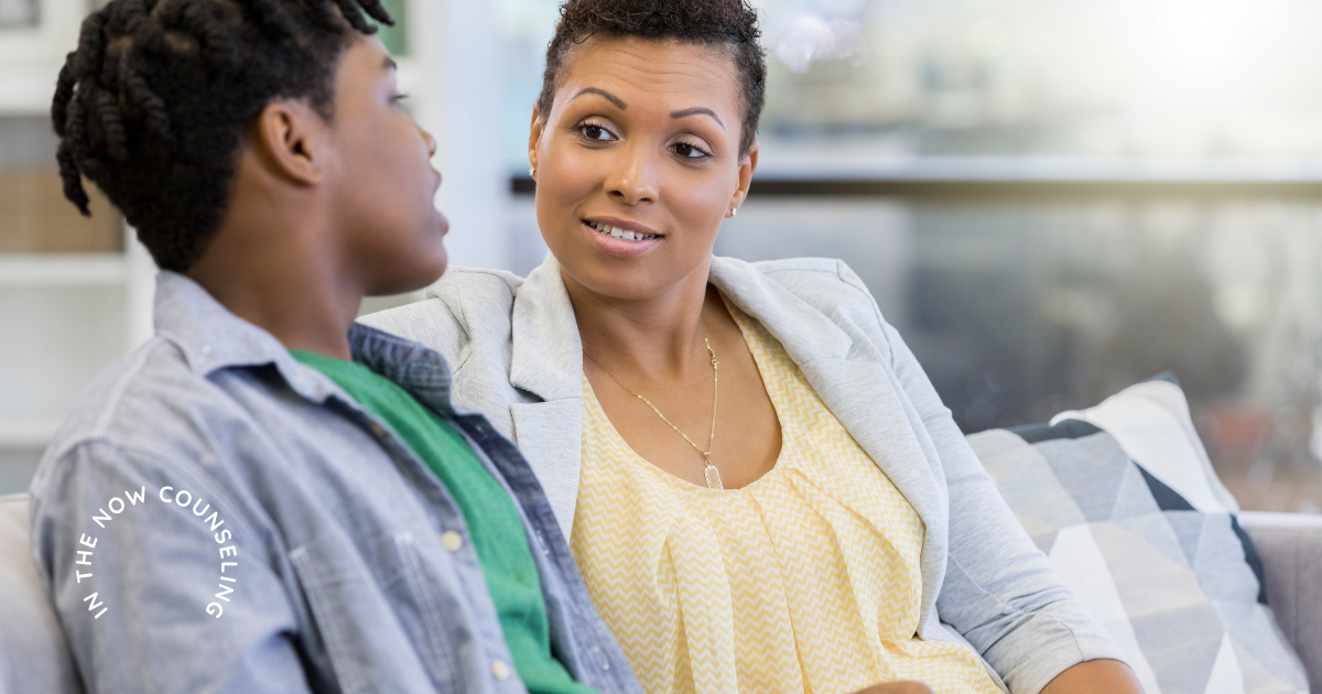 Mother sitting quietly beside her teen who shut down emotionally creating a calm space for conversation.