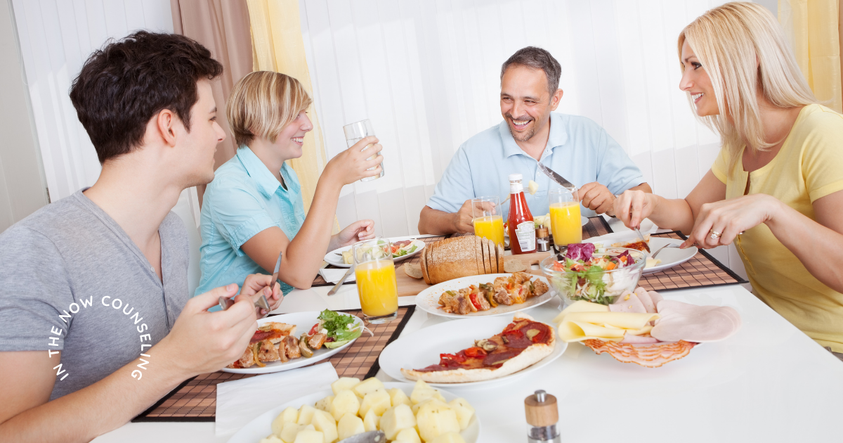 Family eating dinner together at home as they reset after summer as it comes to an end